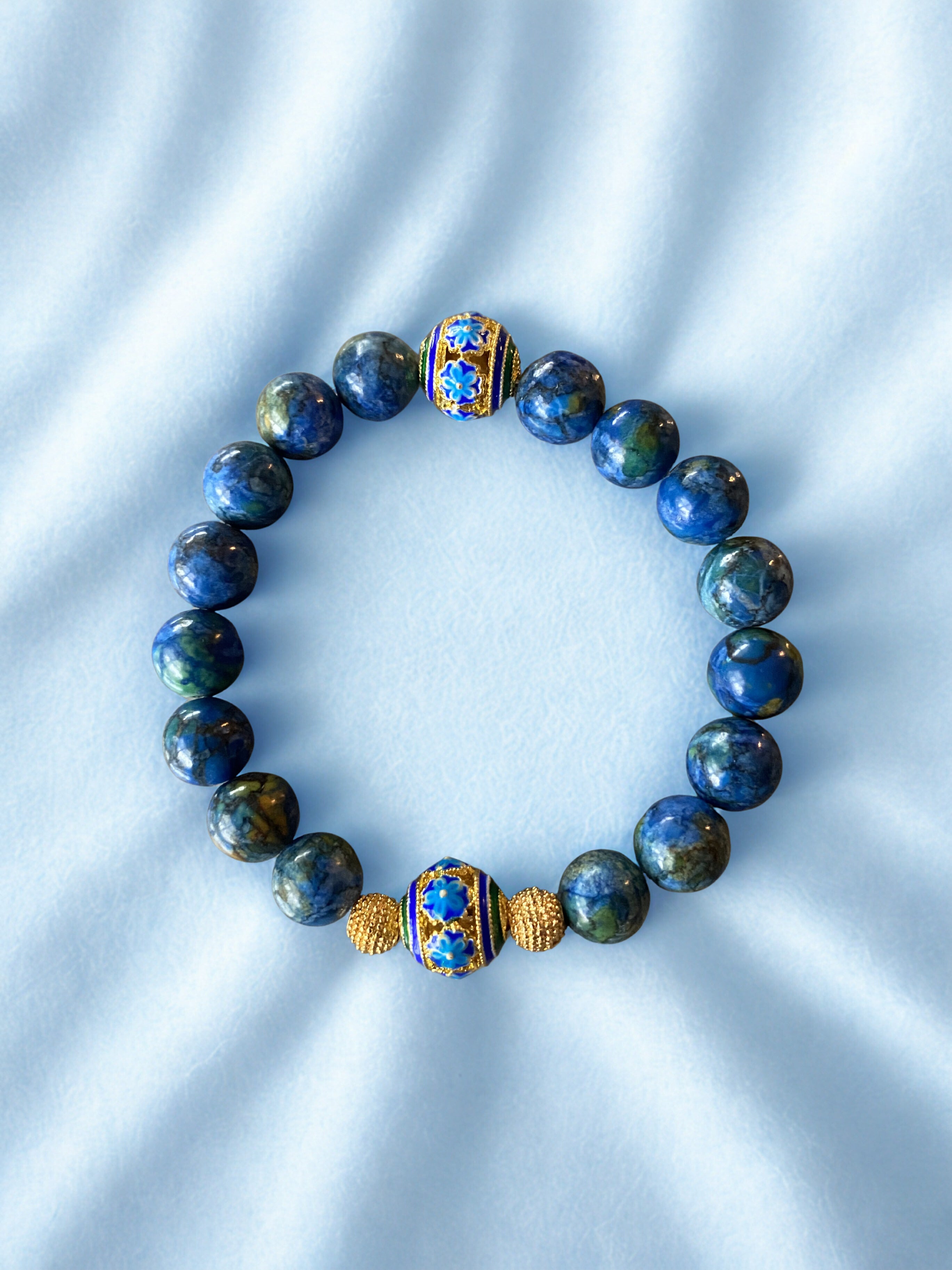 Handmade bracelet with swirls of Blue, green and gold