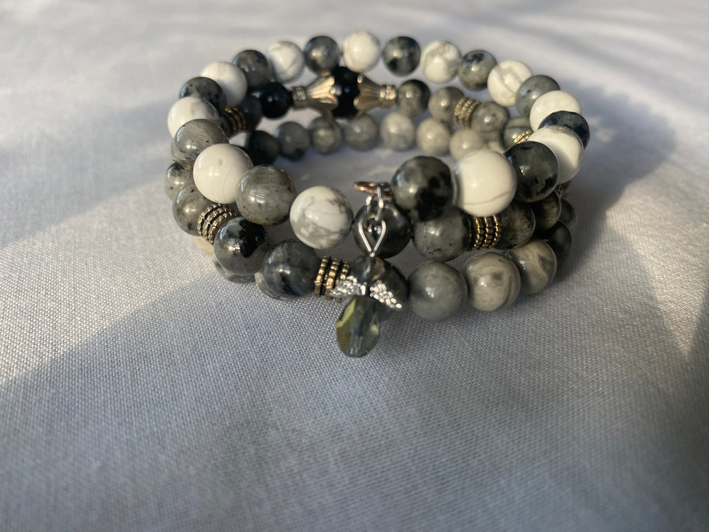 Guardian Angel Handmade Bracelet stacked on shades of gray.