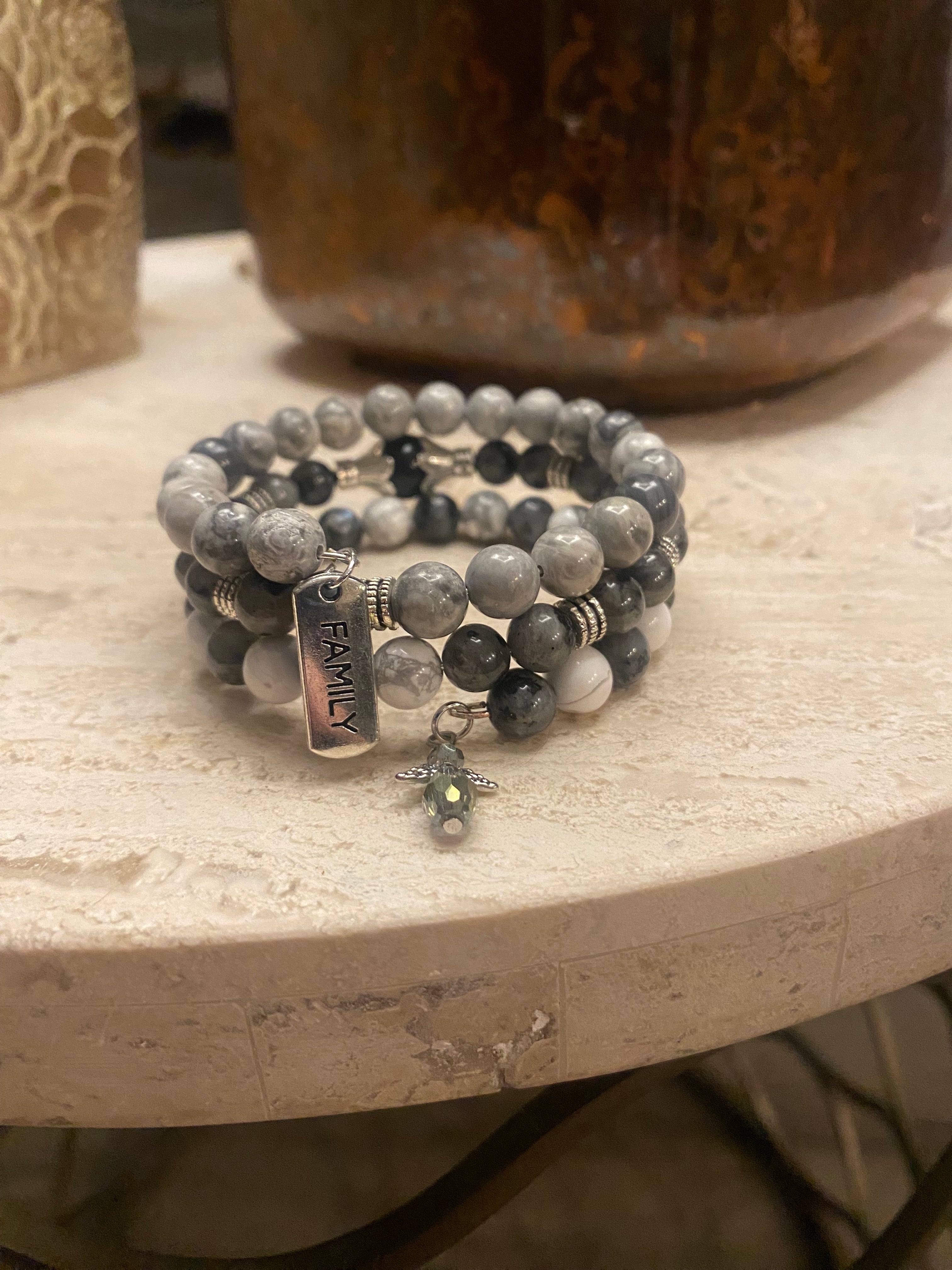 Guardian Angel Handmade Bracelet stacked on shades of gray.