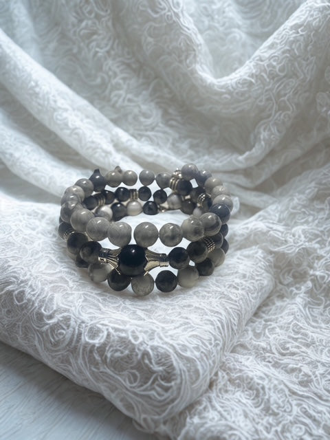 Guardian Angel Handmade Bracelet stacked on shades of gray.